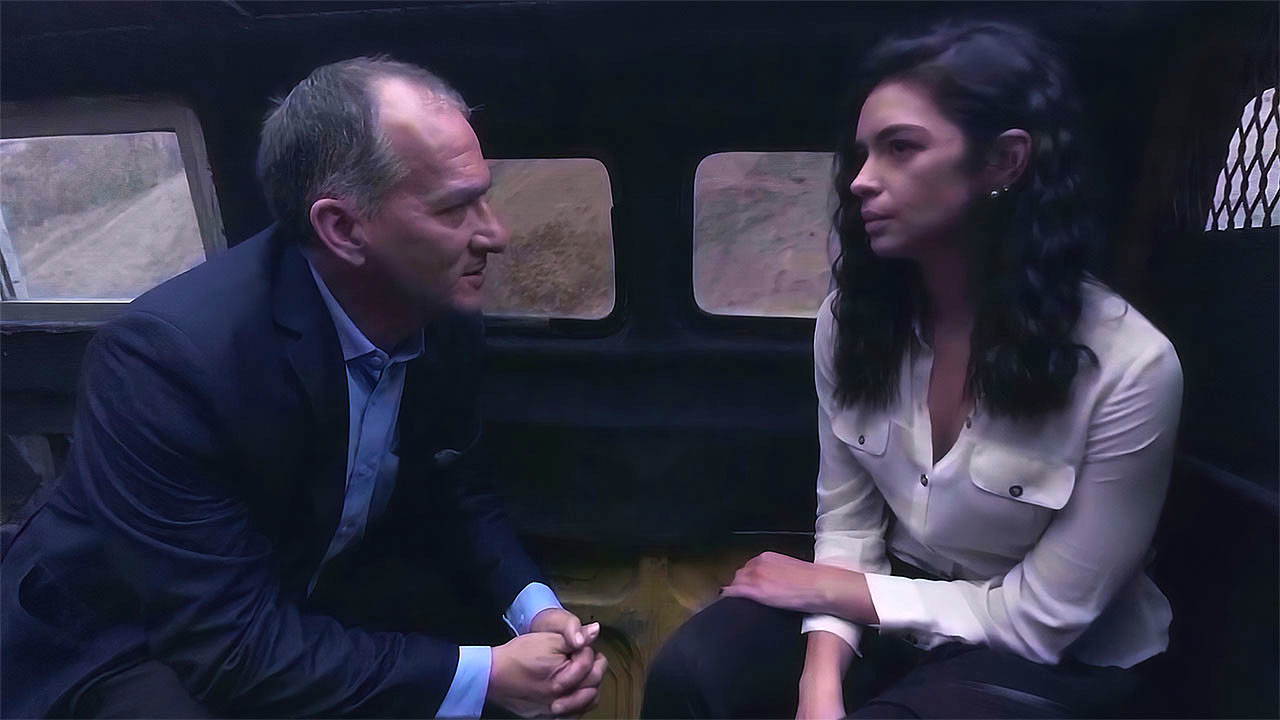 Two passengers in a tense conversation inside the van