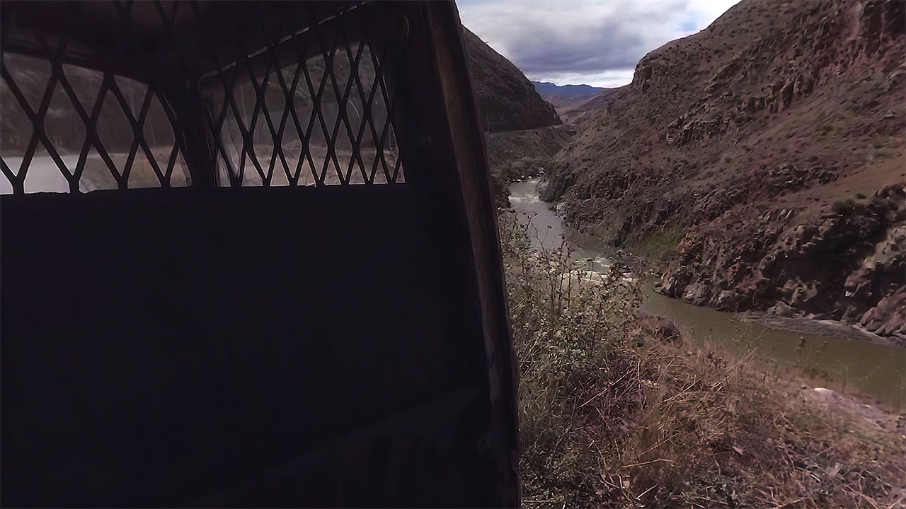 A man flags down the van on an empty mountain road